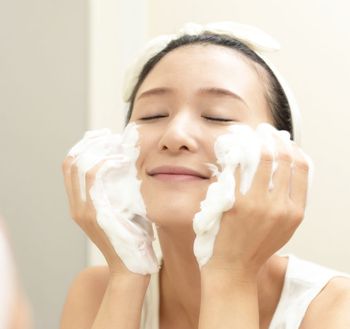 asian woman washing her face